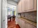 Pantry area featuring granite counters, cabinets, and views into a dining area at 1504 Hemlock Hill Dr, Durham, NC 27703