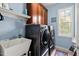 Convenient laundry room with modern washer and dryer units, plus ample cabinet space at 1504 Hemlock Hill Dr, Durham, NC 27703