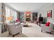 Cozy living room with gray walls, built-in shelves, a stone fireplace, and comfortable seating for relaxation at 1504 Hemlock Hill Dr, Durham, NC 27703