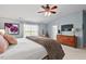 Well-lit bedroom with a comfortable bed, dresser, and a view of the outdoors at 1504 Hemlock Hill Dr, Durham, NC 27703