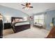 Spacious bedroom with a large bed, ceiling fan, and serene natural light at 1504 Hemlock Hill Dr, Durham, NC 27703