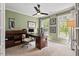 Home office featuring a ceiling fan, natural light from two windows, and a view of the front yard at 1504 Hemlock Hill Dr, Durham, NC 27703