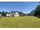 A view of the exterior of the house with a large lawn and fencing at 160 Inverness St, Zebulon, NC 27597