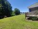 Spacious backyard featuring green grass, a fence, and a view of the house at 160 Inverness St, Zebulon, NC 27597