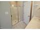 Bathroom with stand-up shower with glass doors, tile floors, and double sink vanity at 160 Inverness St, Zebulon, NC 27597