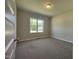 Bright bedroom with a large window, plush carpet, and neutral paint at 160 Inverness St, Zebulon, NC 27597