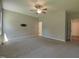 Large bedroom featuring neutral walls, carpet, ceiling fan, and a TV mount, providing a comfortable space at 160 Inverness St, Zebulon, NC 27597