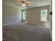 Bright bedroom with a ceiling fan, carpet, two windows offering view at 160 Inverness St, Zebulon, NC 27597