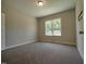 Cozy bedroom with carpet, neutral paint, and a view to the outside at 160 Inverness St, Zebulon, NC 27597