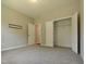 Bedroom featuring carpet, neutral paint, and an open closet with shelving at 160 Inverness St, Zebulon, NC 27597