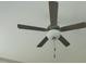 Ceiling fan with five dark blades and globe light fixture hanging from the ceiling at 160 Inverness St, Zebulon, NC 27597