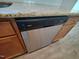 Stainless steel Whirlpool dishwasher integrated into wooden cabinets with granite countertop at 160 Inverness St, Zebulon, NC 27597