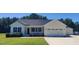 Beautiful single-story home with attached garage and manicured lawn and inviting front porch at 160 Inverness St, Zebulon, NC 27597