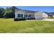 Charming single-story home with manicured lawn, attached garage, and flower-lined porch at 160 Inverness St, Zebulon, NC 27597