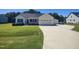 Beautiful single-story home with attached garage and manicured lawn and inviting front porch at 160 Inverness St, Zebulon, NC 27597