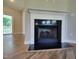 Elegant fireplace with sleek black surround and white mantel, creating a cozy and inviting focal point at 160 Inverness St, Zebulon, NC 27597