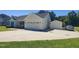 Home with large driveway, a two car garage, and a matching one car garage to the side at 160 Inverness St, Zebulon, NC 27597