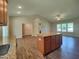 Well-appointed kitchen island with granite countertop providing extra storage and serving space, with views to living area at 160 Inverness St, Zebulon, NC 27597
