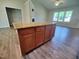 Kitchen island with granite countertop providing extra storage and serving space, with views to living area and fireplace at 160 Inverness St, Zebulon, NC 27597