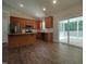 Modern kitchen with stainless steel appliances, granite countertops, and sliding glass doors leading to an outdoor deck at 160 Inverness St, Zebulon, NC 27597