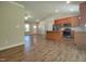 Spacious open floor plan with hardwood floors connecting the living area, kitchen, and dining spaces at 160 Inverness St, Zebulon, NC 27597