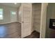 Walk in pantry next to stainless refrigerator and wire rack on door for storage and organization at 160 Inverness St, Zebulon, NC 27597
