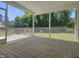 View of screened porch that overlooks an expansive fenced yard and beautiful trees at 160 Inverness St, Zebulon, NC 27597