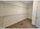 Large walk-in closet with carpet and built-in shelving for organization and storage at 160 Inverness St, Zebulon, NC 27597