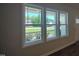 Bright interior with large windows offering scenic views of the landscaped front yard and neighboring homes at 160 Inverness St, Zebulon, NC 27597
