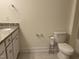 Bright bathroom features a toilet, vanity with a granite countertop, and modern fixtures at 185 Bourne Dr, Franklinton, NC 27525