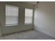This bedroom features two windows with blinds, neutral paint and plush carpet at 185 Bourne Dr, Franklinton, NC 27525