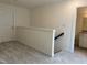 Upstairs hallway with carpet flooring leads to the bathroom with granite countertop vanity at 185 Bourne Dr, Franklinton, NC 27525
