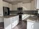 Kitchen featuring white cabinets, granite countertops, stainless steel appliances, and a center island at 185 Bourne Dr, Franklinton, NC 27525