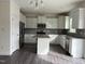 Modern kitchen featuring an island, stainless steel appliances, and white cabinetry at 185 Bourne Dr, Franklinton, NC 27525