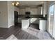 Beautiful kitchen with stainless steel appliances, white cabinets, granite countertops, and sleek hardwood floors at 185 Bourne Dr, Franklinton, NC 27525
