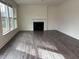 Bright living room featuring a fireplace, large windows, and wood flooring, ideal for entertaining at 185 Bourne Dr, Franklinton, NC 27525