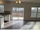 Bright, airy living space with hardwood floors, a sliding glass door, and large windows at 185 Bourne Dr, Franklinton, NC 27525
