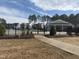Community pool area features a clear blue pool, surrounded by fencing, and lush landscaping at 185 Bourne Dr, Franklinton, NC 27525