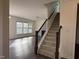 Carpeted staircase with wooden banister leading to the upper level, providing easy access at 185 Bourne Dr, Franklinton, NC 27525