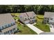 Aerial shot of a lovely home with a long driveway, lush lawn, and mature trees at 185 Twilight Trl, Willow Springs, NC 27592