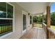 Lovely back porch with wood floors and railings and a great view of the backyard at 185 Twilight Trl, Willow Springs, NC 27592