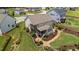 Aerial view of a private backyard with a screened porch, patio, and beautifully landscaped gardens at 185 Twilight Trl, Willow Springs, NC 27592