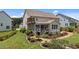 A well-maintained backyard, a screened in porch, and professional landscaping at 185 Twilight Trl, Willow Springs, NC 27592