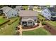 Landscaped backyard featuring a stone walkway, screened porch, and mature trees at 185 Twilight Trl, Willow Springs, NC 27592