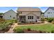 Picturesque backyard featuring a manicured lawn, a screened-in porch, and vibrant landscaping at 185 Twilight Trl, Willow Springs, NC 27592