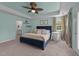 Bright bedroom features blue accent wall and blue bed frame, a ceiling fan, and an en suite bathroom at 185 Twilight Trl, Willow Springs, NC 27592