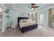 This bedroom features tranquil paint, a ceiling fan, and access to the backyard at 185 Twilight Trl, Willow Springs, NC 27592