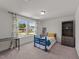 A cozy bedroom with a blue bed frame, carpeted floors, and a window with patterned curtains at 185 Twilight Trl, Willow Springs, NC 27592