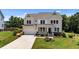 Beautiful two-story home showcasing manicured landscaping and a welcoming front porch at 185 Twilight Trl, Willow Springs, NC 27592