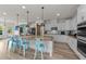 Spacious kitchen features a large island with pendant lighting, white cabinetry, and stainless steel appliances at 185 Twilight Trl, Willow Springs, NC 27592